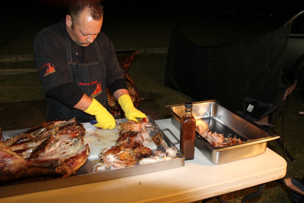 Professional chef carving slow-roasted lamb on-site for a private function in Gqeberha and Kariega by Pedros Asado