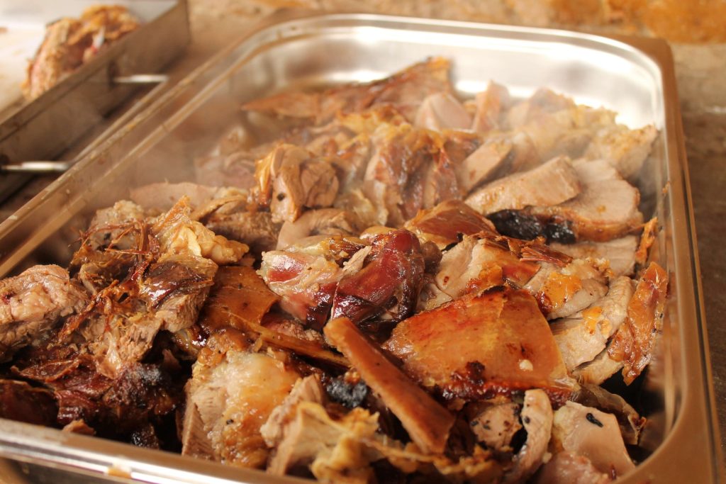 Close-up of hand-carved spitbraai lamb being sliced for a Pedros Asado event
